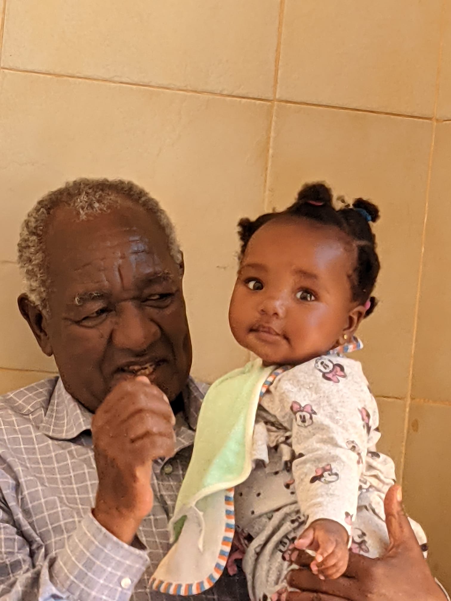 Clement cradling granddaughter