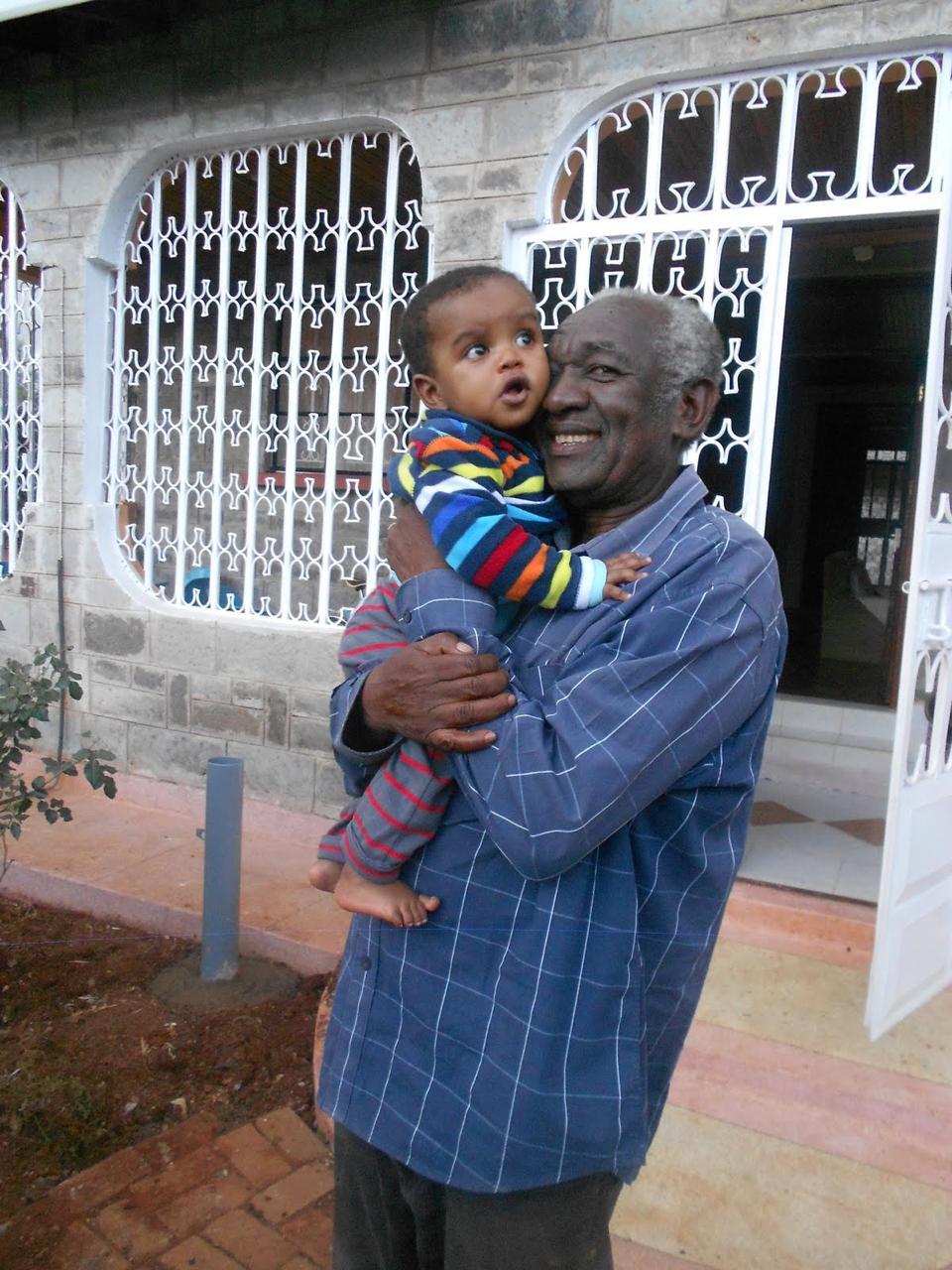 Clement holding grandbaby