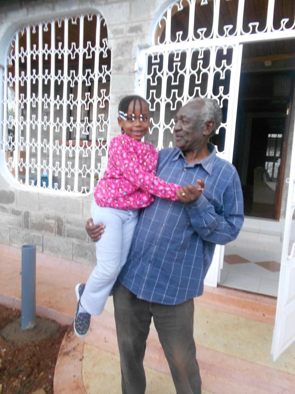 Clement holding granddaughter in pink