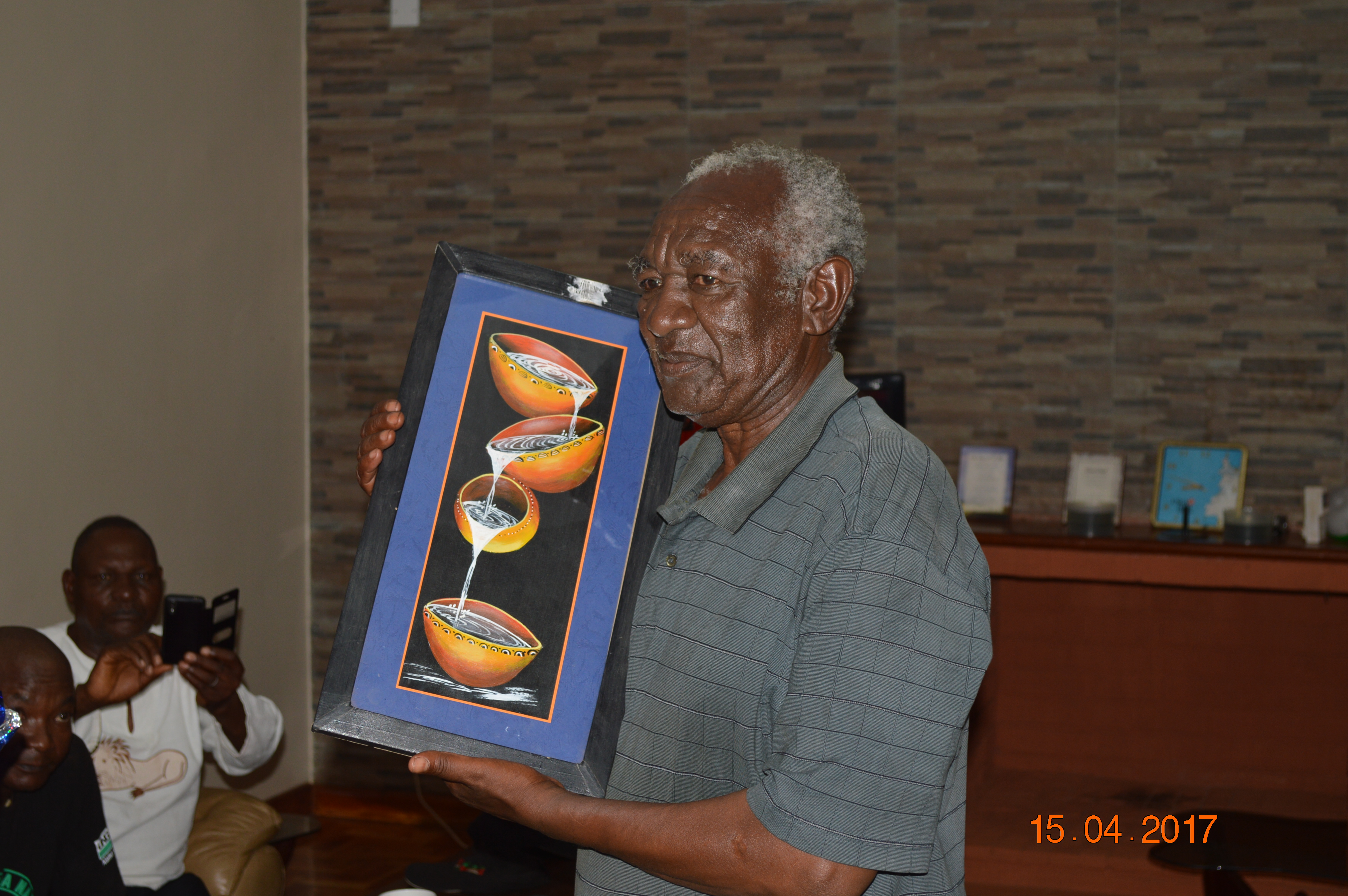 Clement holding painting gift