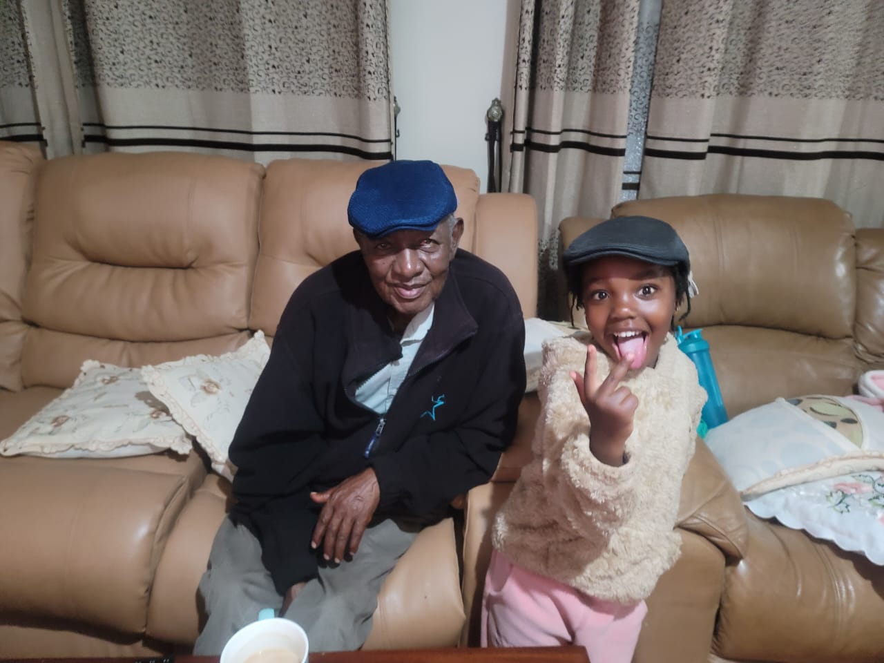 Clement and granddaughter in matching caps