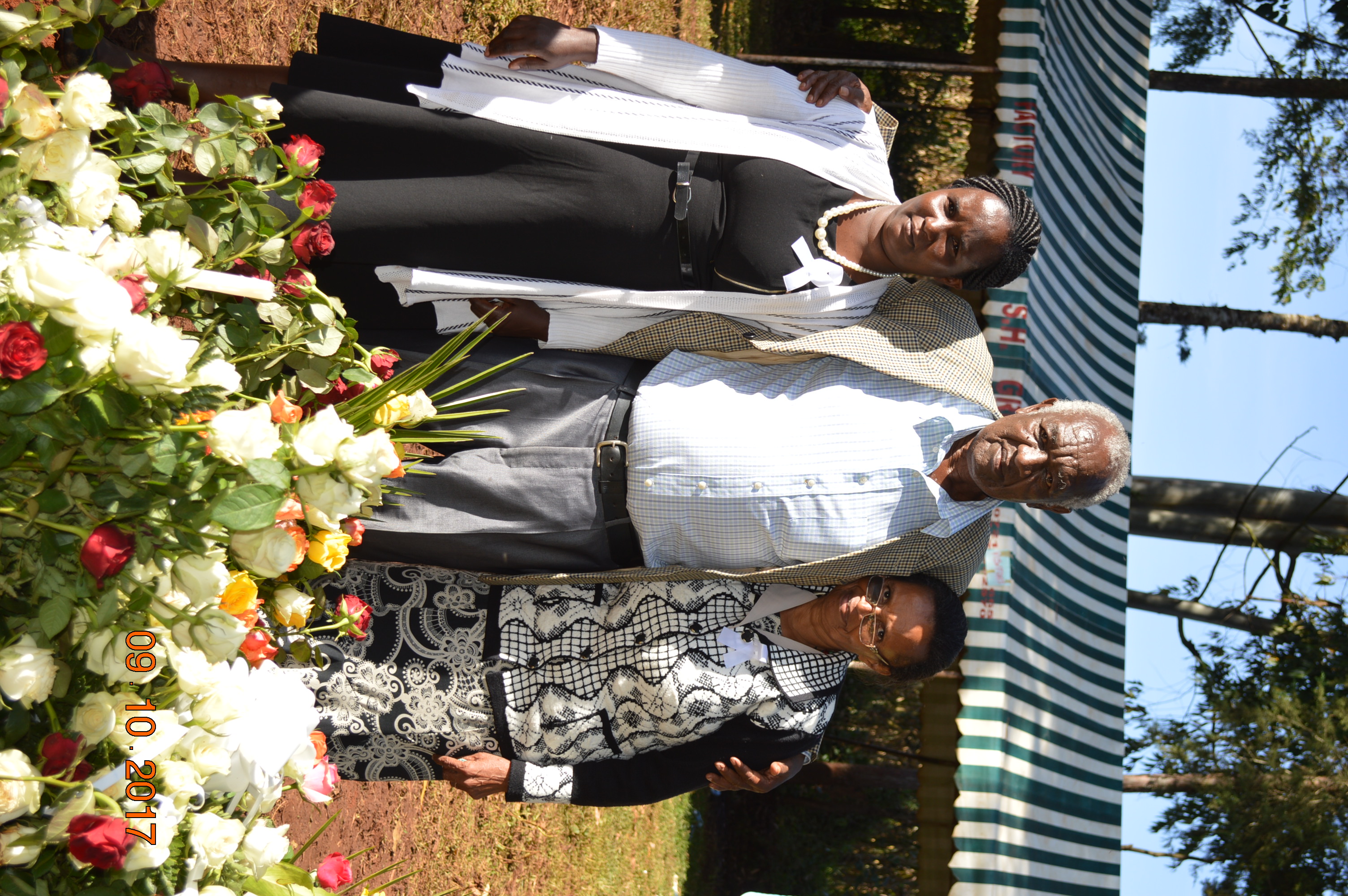Clement with family by flowers